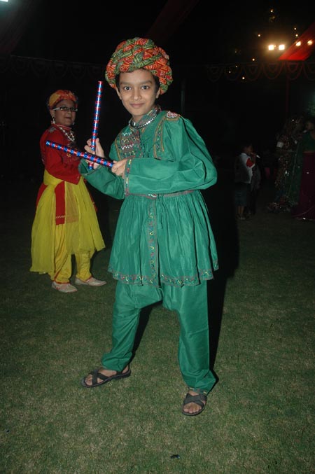 A young dandiya dancer in a green costume